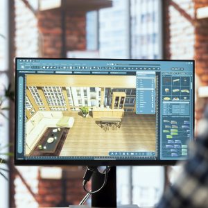 Interior designer uses architectural software to show customers what their home will look like after finishing remodeling commission. Man preparing visual preview for clients on PC, close up